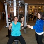 Gina tackles the equipment with Carolyn at the sideline.