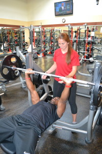 A personal trainer helps accomplish an appropriate (post-holiday cookies) workout.