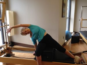 Marian using the Pilates reformer.