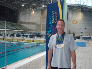 Scott at the 2009 World Masters Games in Sydney. Proudly displaying medals: Gold 100m Fly; Silver 50m Fly, 50m Free, 200m Free; and Bronze 100m Free.