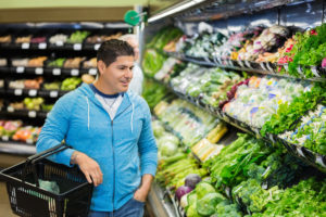 Hispanic man shopping for healthy food in supermarket